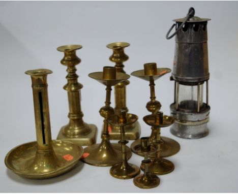 A mid 20th century miner's safety lamp, together with a pair of Victorian turned brass candlesticks, various other brass cand