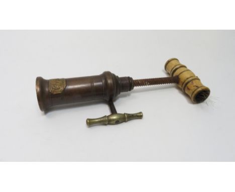 A Dowler patent corkscrew with turned bone handle, nickle plated side handle, solid brass barrel with applied patent plate, t