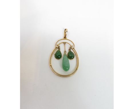 A three stone jade pendant, the oval unmarked frame with two shallow tear shaped cabochons and a larger pipkin shaped drop wi