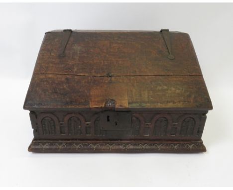 A late 18th century carved oak Bible box having sloping hinged cover enclosing interior with small drawers and shelf, 31cm hi