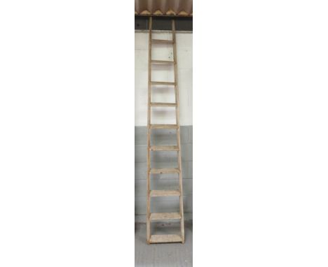 A late 19th/early 20th century wooden 10 rung ladder of tapering form, 252cm long