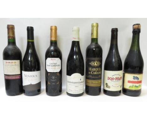 A collection of seven bottles of red and white wine, various dates