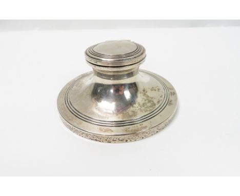 A loaded silver capstan shaped inkwell, London 1923, with reeded borders, 11.3 cm diameter