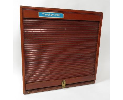 A 20th century GWR ticket cabinet the rectangular wood cabinet with tambour front enclosing five racks and with original bras