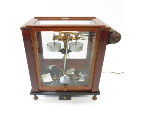 A scientific balance scales, in a mahogany and glass frame