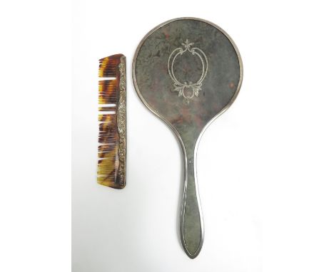 A silver tortoiseshell pique work hand mirror; with a hair comb with an embossed spine stamped 'Sterling Silver'