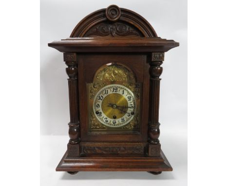 A 20th century domed top oak cased mantel clock
