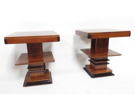 A pair of Art Deco style teak rectangular occasional tables with lower shelf tier and on shaped base, 61cm high