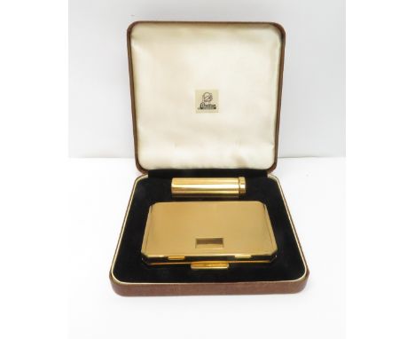 A Stratton gilt metal powder compact and lipstick holder in original case
