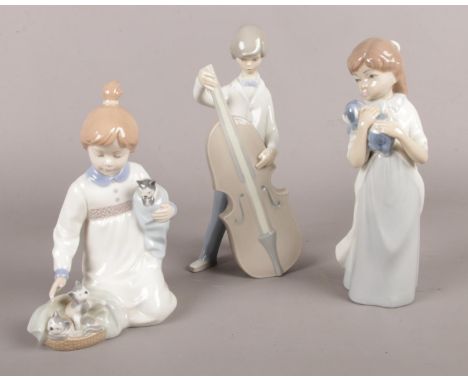 Three Lladro/Nao figurines. girl with kittens, boy with cello etc  damage to top of cello on figurine