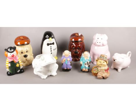 A quantity of novelty ceramic items. Includes biscuit barrels, frog planter and money boxes.  
