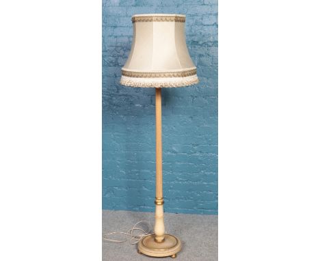 A turned and reeded standard lamp on circular base.  