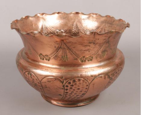 A copper arts &amp; crafts planter with hammered and engraved decoration.  