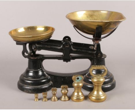 A set of weighing scales with brass bowls and weights (¼oz-1lb).  