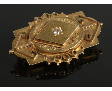 A yellow metal art deco brooch, set with large (¼ct) single diamond. Total weight: 9.45g  