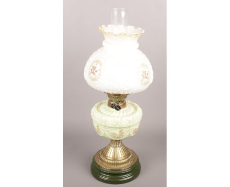 A glass oil lamp with floral decoration.  