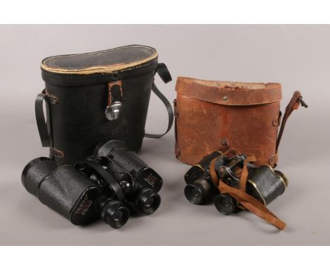A cased pair of ETABL world war one binoculars along with a pair of Tasco 10x50 Model 312 binoculars.  