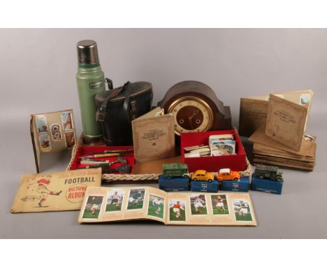 A tray of collectables. To include a Smiths wooden mantle clock with key, a cased pair of Zenith 10x50 binoculars, sixteen al