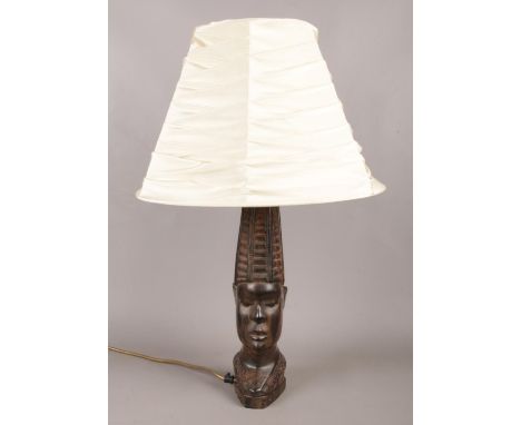 A hardwood table lamp with cream shade, depicted as a Tribal figure head. In working order.  
