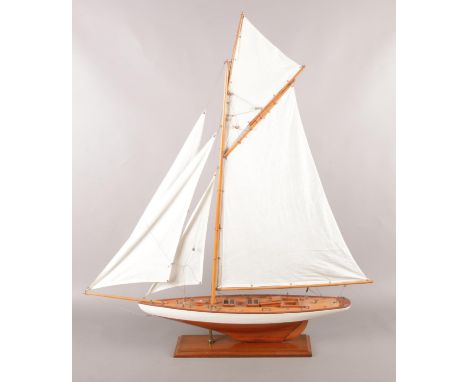 A model of a sail boat raised on a plinth. 93cm  