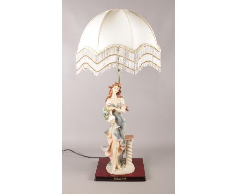 A large ceramic figural table lamp, with frilled cream shade. From the Juliana Collection, stamped 1985. In working order.  