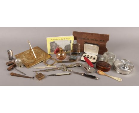 A large quantity of collectables. To include brass sundial top, calipers, portable ash tray and lighter and folding pocket kn