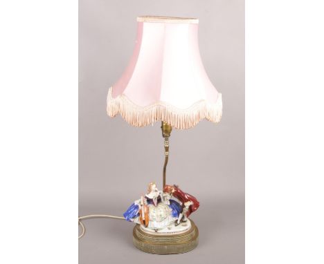A ceramic figural table lamp. Formed as a courting couple. (76cm)  