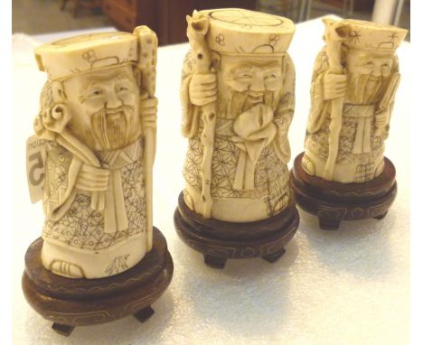 Three carved antique ivory wise men figures on wooden stands 