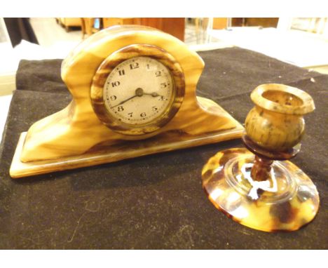 Small celluloid dressing table clock and a single candlestick