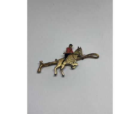 A STOCK PIN DEPICTING A HUNTSMAN AND WHIP