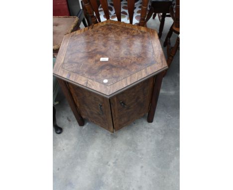 A HEXAGONAL TABLE ENCLOSING TWO CUPBOARDS, 24" ACROSS