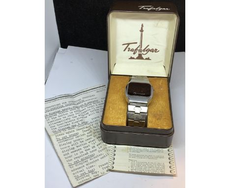 A VINTAGE TRAFALGAR FIVE FUNCTION DIGITAL WATCH WITH STAINLESS STEEL CASE AND STRAP, ORIGINAL INSTRUCTIONS AND FURTHER PAPERW