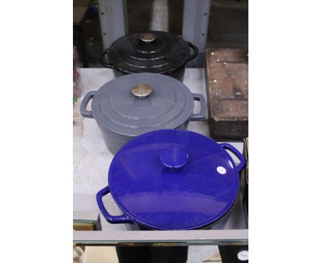 THREE LARGE CAST IRON COOKING POTS