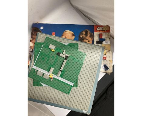 A BOXED VINTAGE LEGO SET PLUS ADDITIONAL LEGO BOARDS.