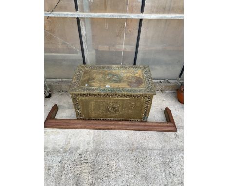 A LARGE BRASS COVERED STORAGE TRUNK AND A WOODEN FIRE FENDER
