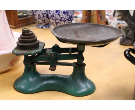 A SET OF VINTAGE GREEN METAL WEIGHING SCALES WITH WEIGHTS