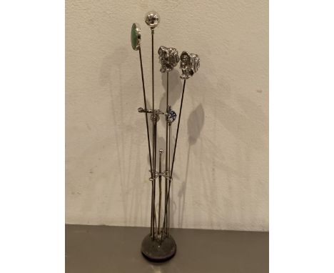 A HAT PIN STAND WITH EIGHT MARKED SILVER HAT PINS