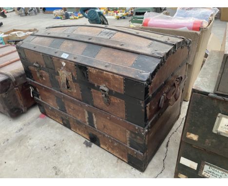 A VINTAGE WOODEN BANDED DOME TOPPED TRAVEL TRUNK