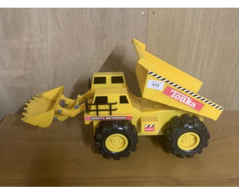 A LARGE YELLOW, MIGHTY MOTORIZED TONKA TRUCK