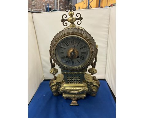 A VINTAGE HEAVY BRASS MANTLE CLOCK WITH WHITE METAL FACE AND ROMAN NUMERALS