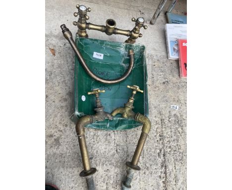 A PAIR OF VINTAGE BRASS SINK TAPS AND A FURTHER VINTAGE STYLE MIXER TAP