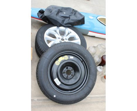 A FIVE STUD SPARE WHEEL AND TYRE AND A FIVE STUD WHEEL AND TYRE