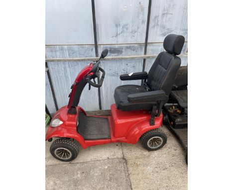 A LARGE RED MOBILITY SCOOTER