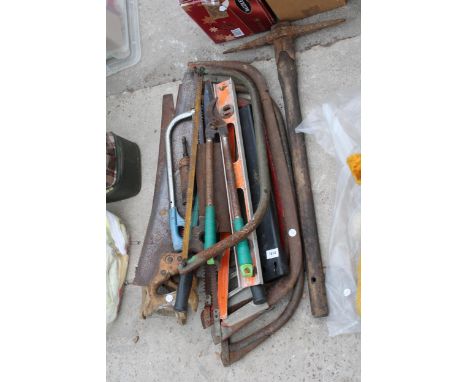 AN ASSORTMENT OF VINTAGE HAND TOOLS TO INCLUDE BOW SAWS, HAND SAWS AND A PICK AXE ETC