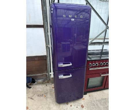 A PURPLE SMEG UPRIGHT FRIDGE FREEZER BELIEVED IN WORKING ORDER BUT NO WARRANTY