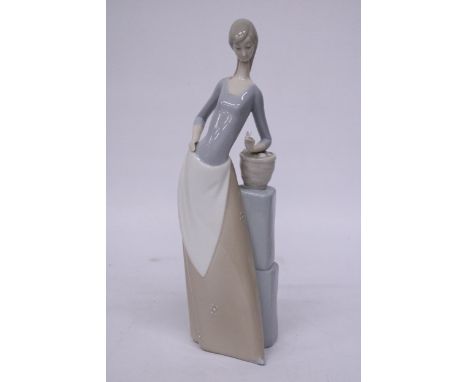 A NAO FIGURE OF A YOUMG WITH HOLDING A BUTTERFLY