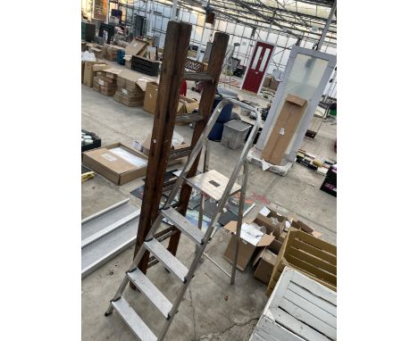 A FOUR RUNG ALLUMINIUM STEP LADDER AND AN EXTENDABLE WOODEN LADDER