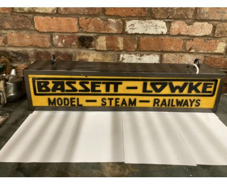 A BASSETT-LOWKE MODEL-STEAM-RAILWAYS DOUBLE SIDED ILLUMINATED SIGN COMPLETE WITH HANGING BRACKET, HEIGHT 19CM, WIDTH 86CM, DE