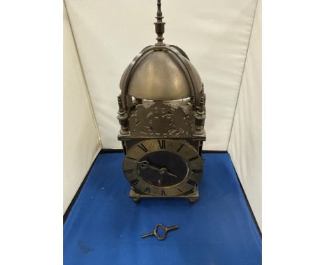 A VERY HEAVY BRASS LANTERN CLOCK WITH KEY