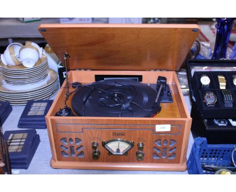 A vintage style Itek record and radio player. Shipping unavailable 